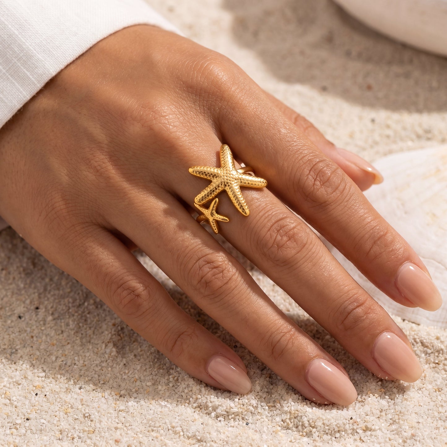 Astérie Ring by VELTRĀ, close-up of sculptural gold starfish details